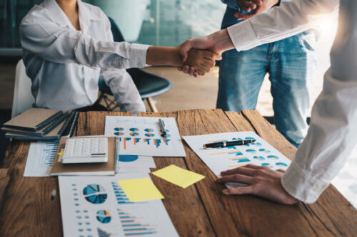 Group of people in an office shaking hands | Ethical Practices in Mortgage Brokering | DG Pinnacle TPO - Miami Wholesale Mortgage Funding Lender