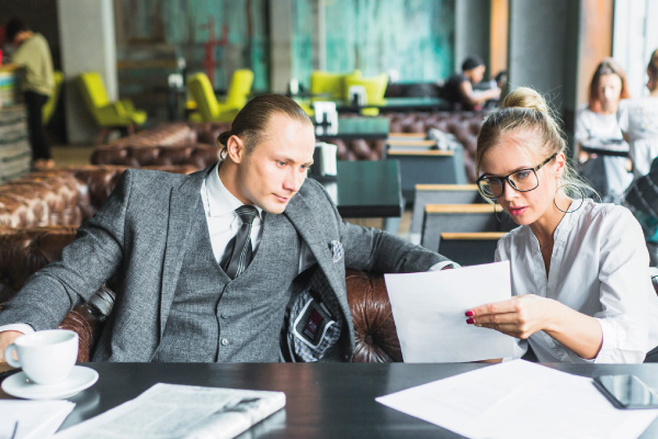 Young man and woman closing business deals in a restaurant - Non-QM DSCR Mortgage Loans | DG Pinnacle TPO - Wholesale Division | Miami Mortgage Lender