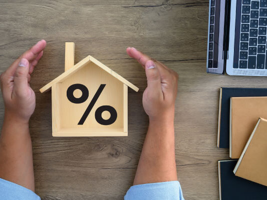 Concept of mortgage rates with model house and male hands | Mortgage rates stuck near 7% | DG Pinnacle TPO - Wholesale Division | Miami Mortgage Lender