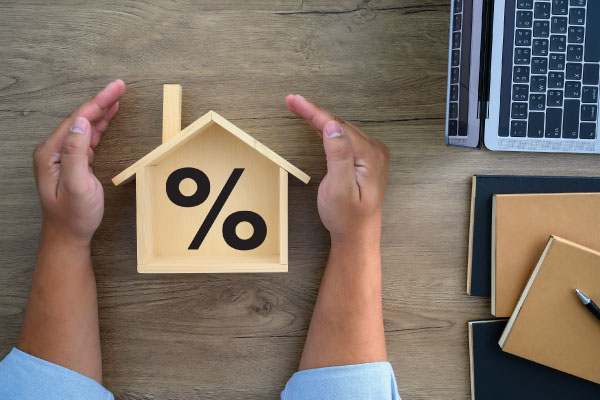 Concept of mortgage rates with model house and male hands | Mortgage rates stuck near 7% | DG Pinnacle TPO - Wholesale Division | Miami Mortgage Lender