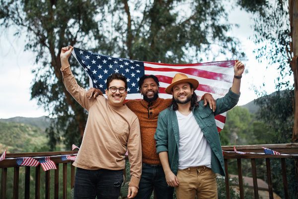 3 men holding american flag | 5 Tips to Work with Foreign National Borrowers | DG Pinnacle TPO - Miami Wholesale Mortgage Funding Lender