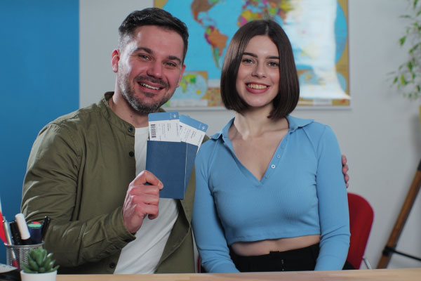 Happy young couple holding their passports | 5 Tips to Work with Foreign National Borrowers | DG Pinnacle TPO - Miami Wholesale Mortgage Funding Lender