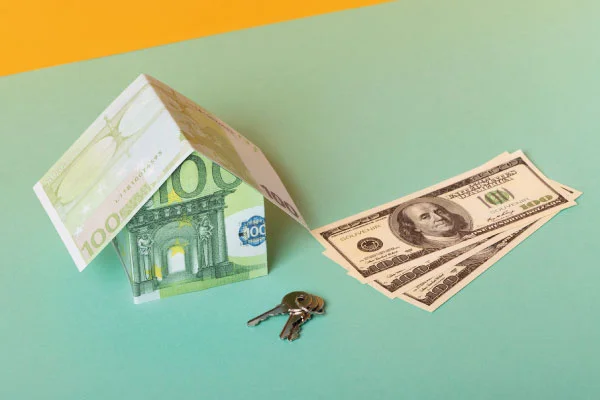 Model house with made with dollar bills next to a pair of keys | 5 money tips to share with your borrowers | DG Pinnacle TPO - Miami Wholesale Mortgage Funding Lender